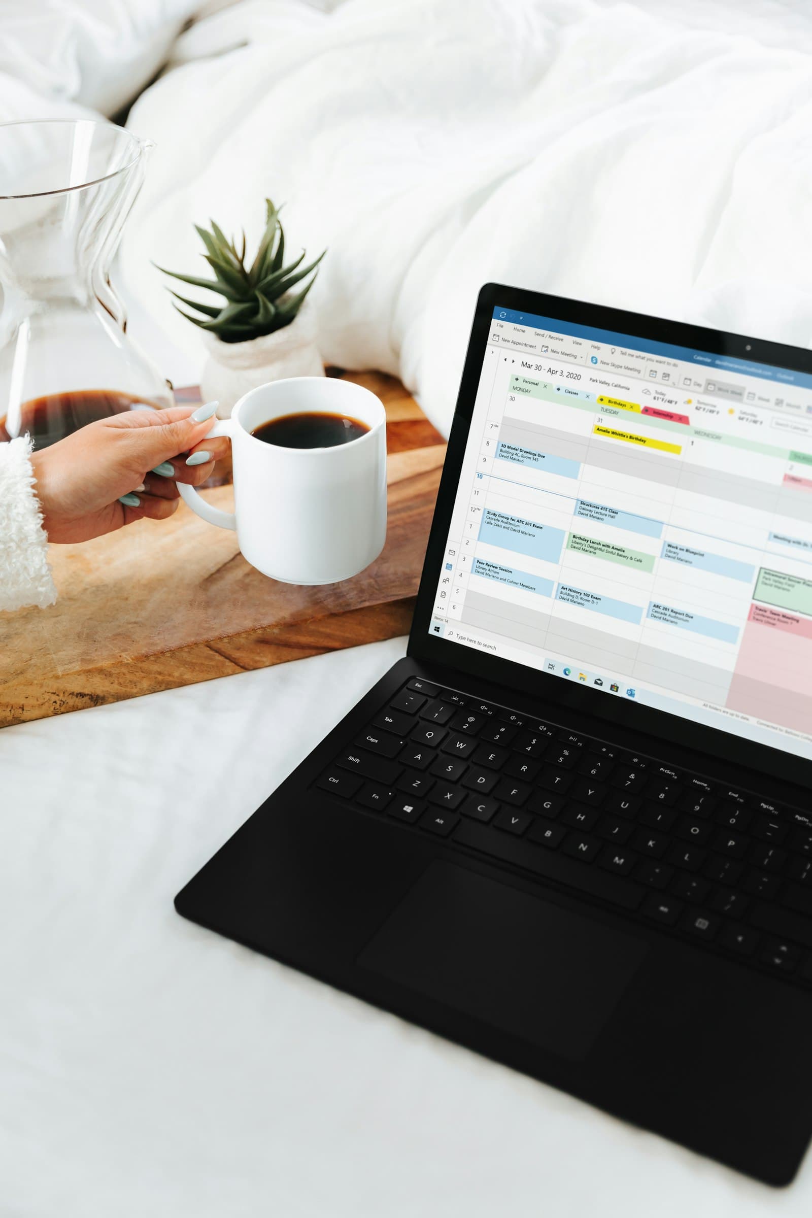 Laptop and coffee mug set up for budget tracker Google Sheets planning