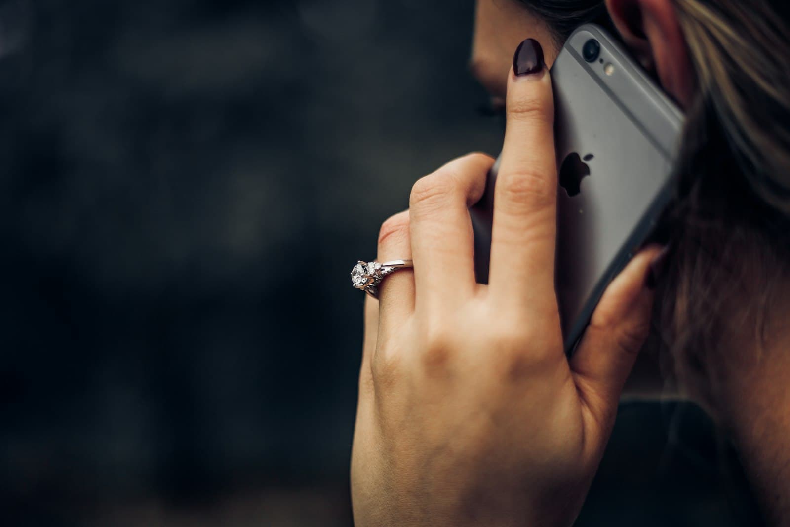 Person talking on the phone, the same way you'd log an expense with a voice expense tracker