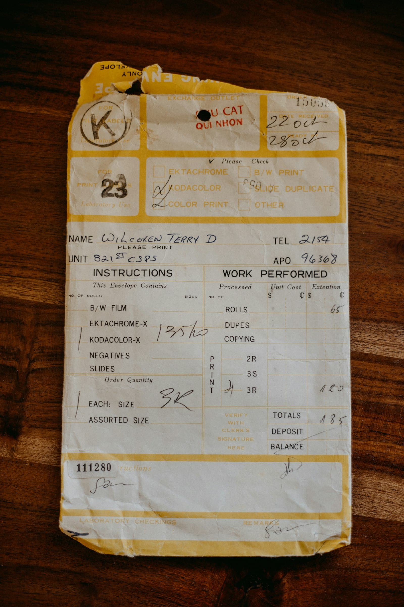 Paper receipt on a wooden table, the kind a QuickBooks receipt scanner processes
