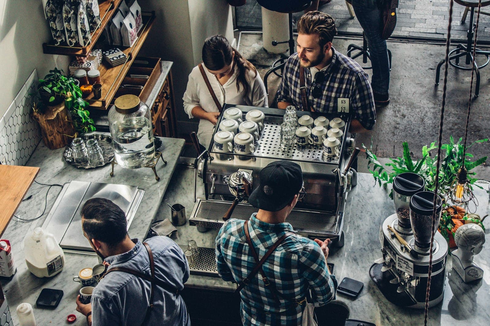 Small business owner reviewing spending at the counter, sorting small business expense categories